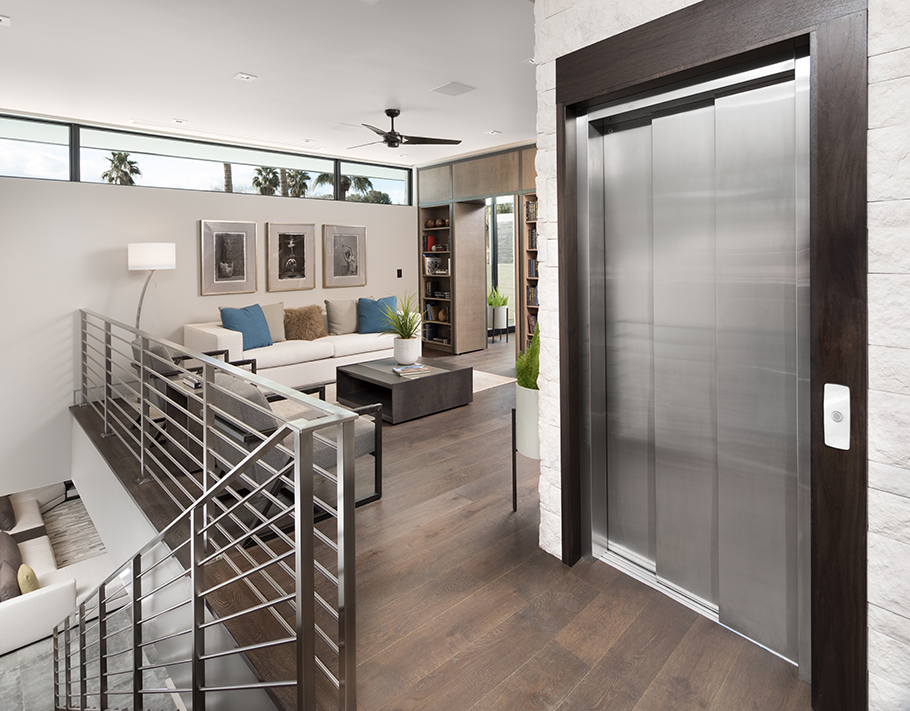 Residential home elevator with stainless steel doors inside a modern living room