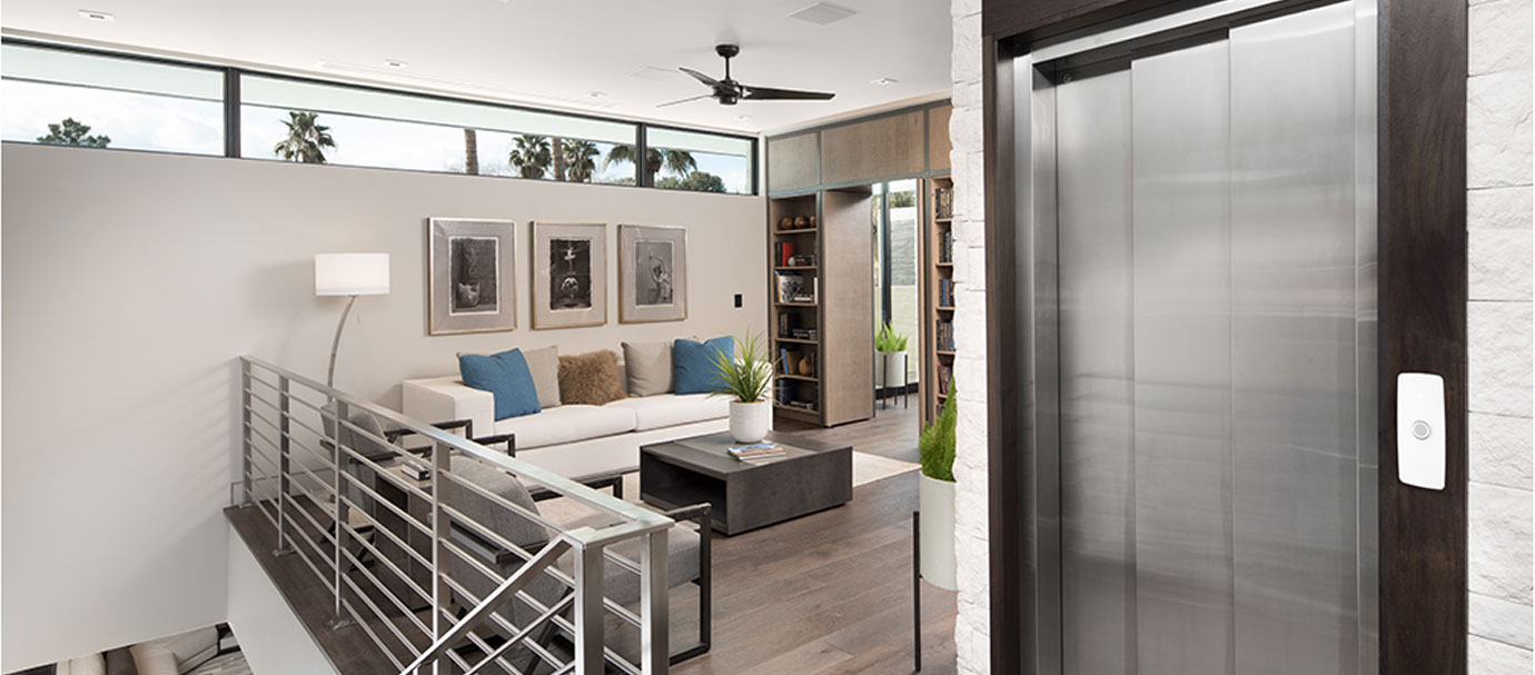 Young boy on Artira Lift on left and home elevator in living room on right