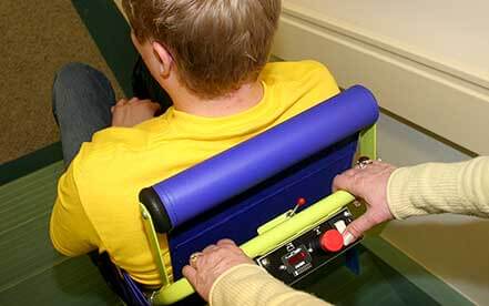 Rear view of man in yellow shirt in the Powertrac power evacuation chair